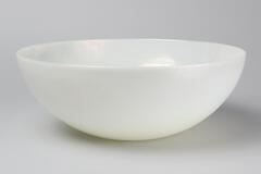 A pearlescent bowl of white with a greenish tint, no rim, very thin.