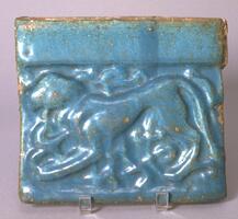 Tile with molded lion motif.