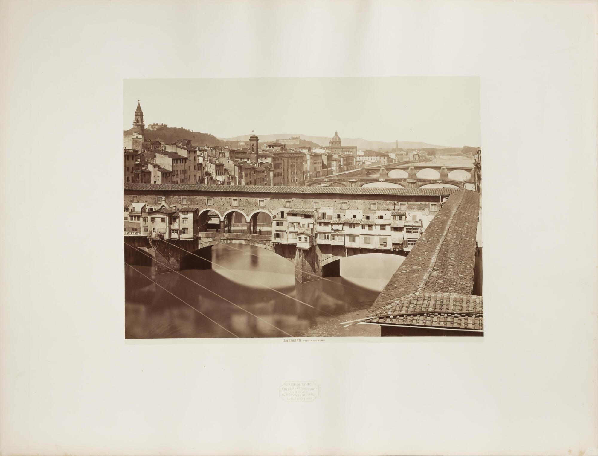 This image depicts a scenic view of three bridges spanning a river that runs through the medieval city of Florence.