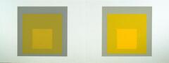 There are two grey squares on a long white horizontal piece of paper with nested squares inside in shades of yellow.