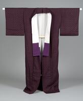 <p>Maroon-violet tsumugi kimono with interwoven geometric kasuri motifs with a purple and white silk lining.</p>
