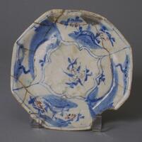 This is a Persian interpretation of a Chinese type which can be dated on the basis of shape--that aspect which the Near Eastern potter chose to adopt. The polygonal alteration of the rim was a late 16th century development in the Chinese tradition. The well-defined scenes and foliage of he Far Eastern model have been more impressionistically rendered and the vocabulary of vegetal forms has been drastically reduced. 