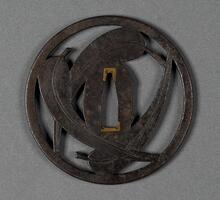 It is a round, openwork tsuba, in the design of three interconnected bamboo leaves. It has the signature: Kishû jû, Sadanobu.