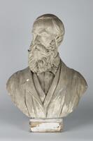 Plaster bust with plaster base. Comb over with moustache and beard.