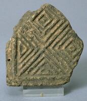 This fragment of molded brick has an impressed concentric diamond pattern. 