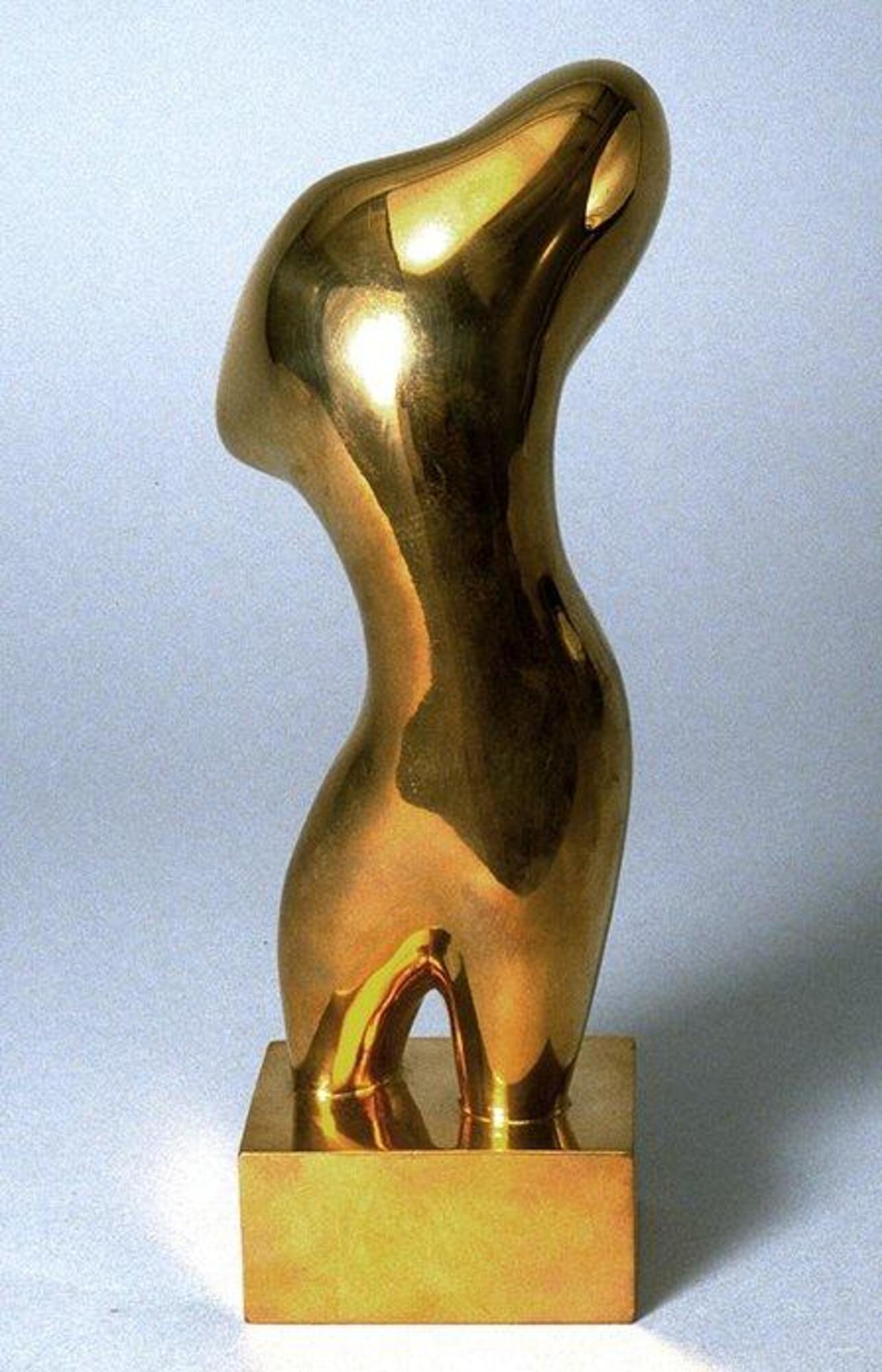 A small polished bronze sculpture of a biomorphic form rising gracefully from a small base. Where it contacts the base, the form stands on two leg-like structures. The form rises from there, narrows, then opens up into a wider, more oblong shape at the top.
