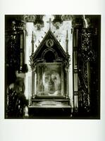 This photograph shows a view of an ornate Catholic reliquary. The reliquary houses a mummified head.