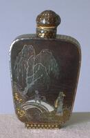 Lacquer burgaute snuff bottle with the design of a&nbsp;willow tree hanging over a bridge with a child walking over it and a man dressed in robes waiting on the other side.