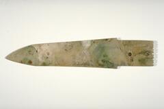 the ceremonial degger-axe replicate in jade a common bronze weapon of the Shang dynasty called ge. It has a wide blade with a sharp point at one end and a plain, rectangular tang on the other.