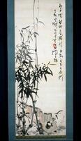 This is a hanging scroll depicting bamboo and a roughly sketched nature scene in the background. To the right edge is a two-line inscription, obscuring a red seal on in the second line. The bamboo is centered on the left edge.&nbsp;