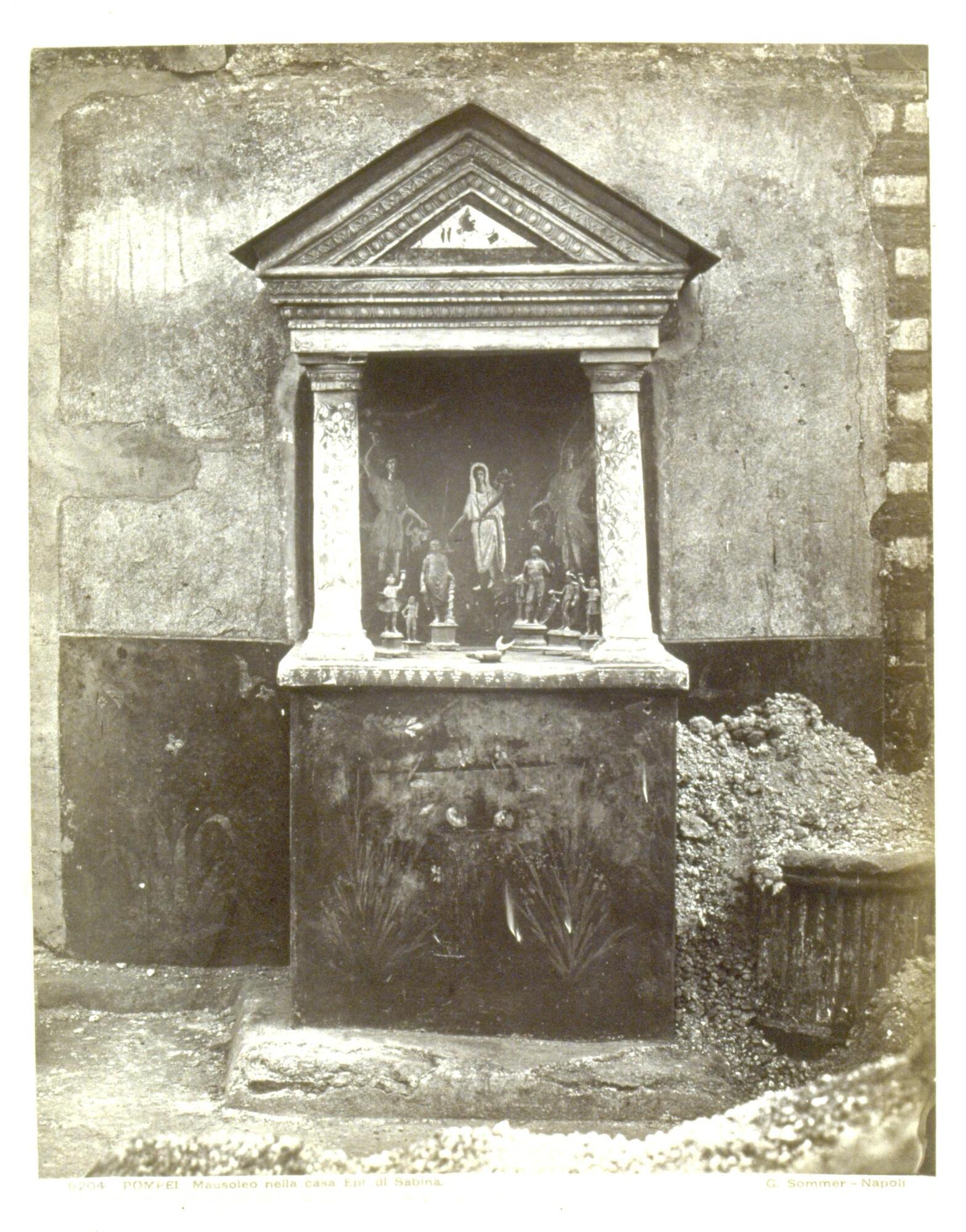 This photograph depicts a head-on view of an ancient Roman shrine.