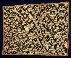 Rectangular pattern with hemmed edges. Panel consists of multiple diamond and rectilinear patterns formed by intersecting lines and chevrons. 