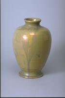 This vase has an iridescent ochre and green glaze. The vessel has a narrow mouth high shoulder.