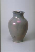 Ceramic vessel with ovular body, rounded shoulder, wide neck and mouth and flared lip covered with iridescent grayish-blue glaze
