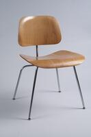 Side chair consisting of separate trapezoidal seat and back mounted on a four-legged metal frame.