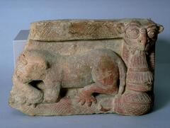 A terracotta block, probably originally part of a frieze around a building, with molded and incised design.