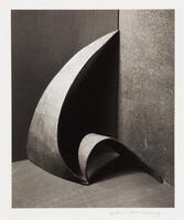 Image of a curved and pointed sculpture in a corner.