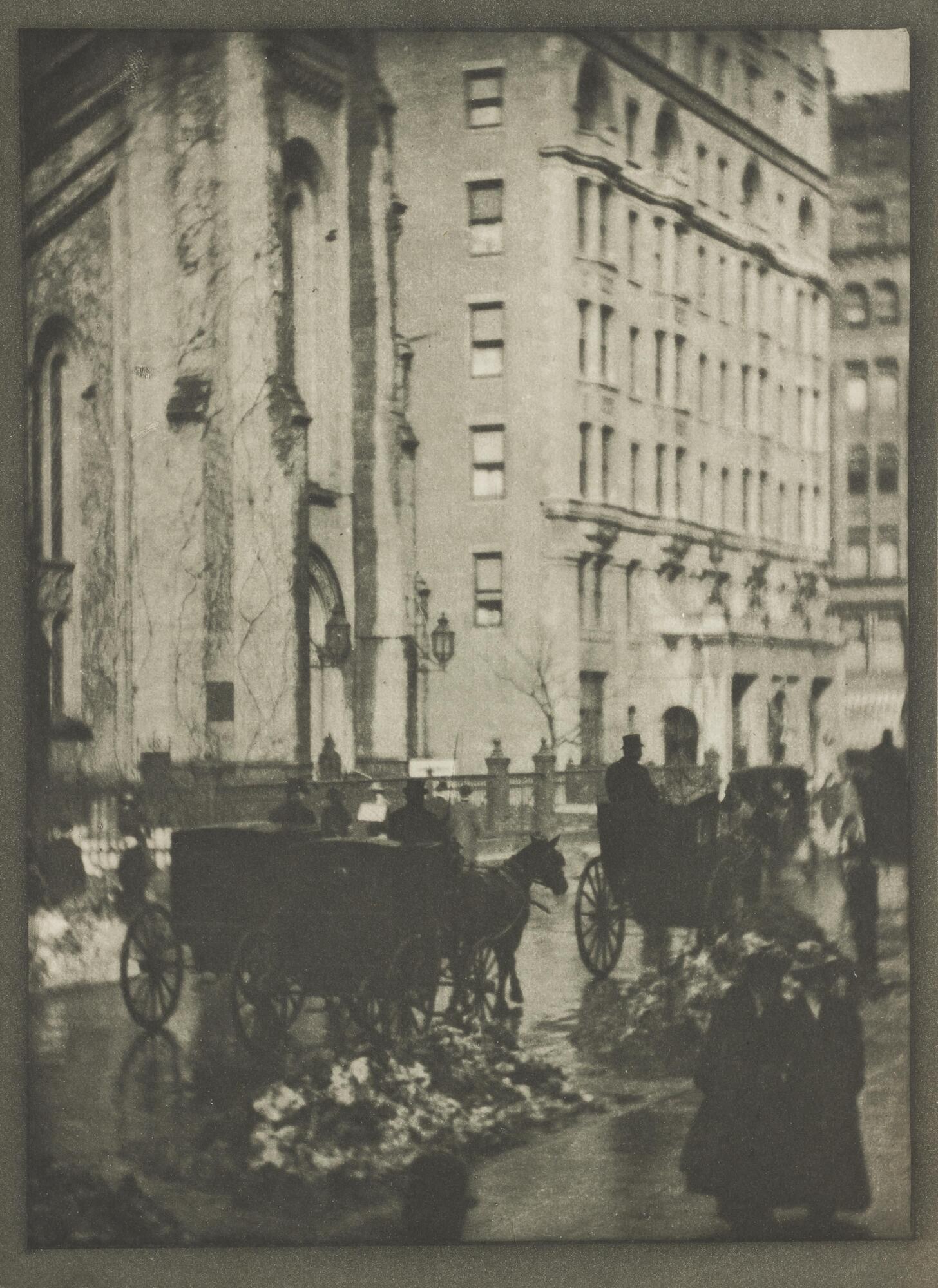 A photograph of the Holland House in New York City. Below the building is a wintery street; silhouetted pedestrians and carriages travel in front of the large hotel.