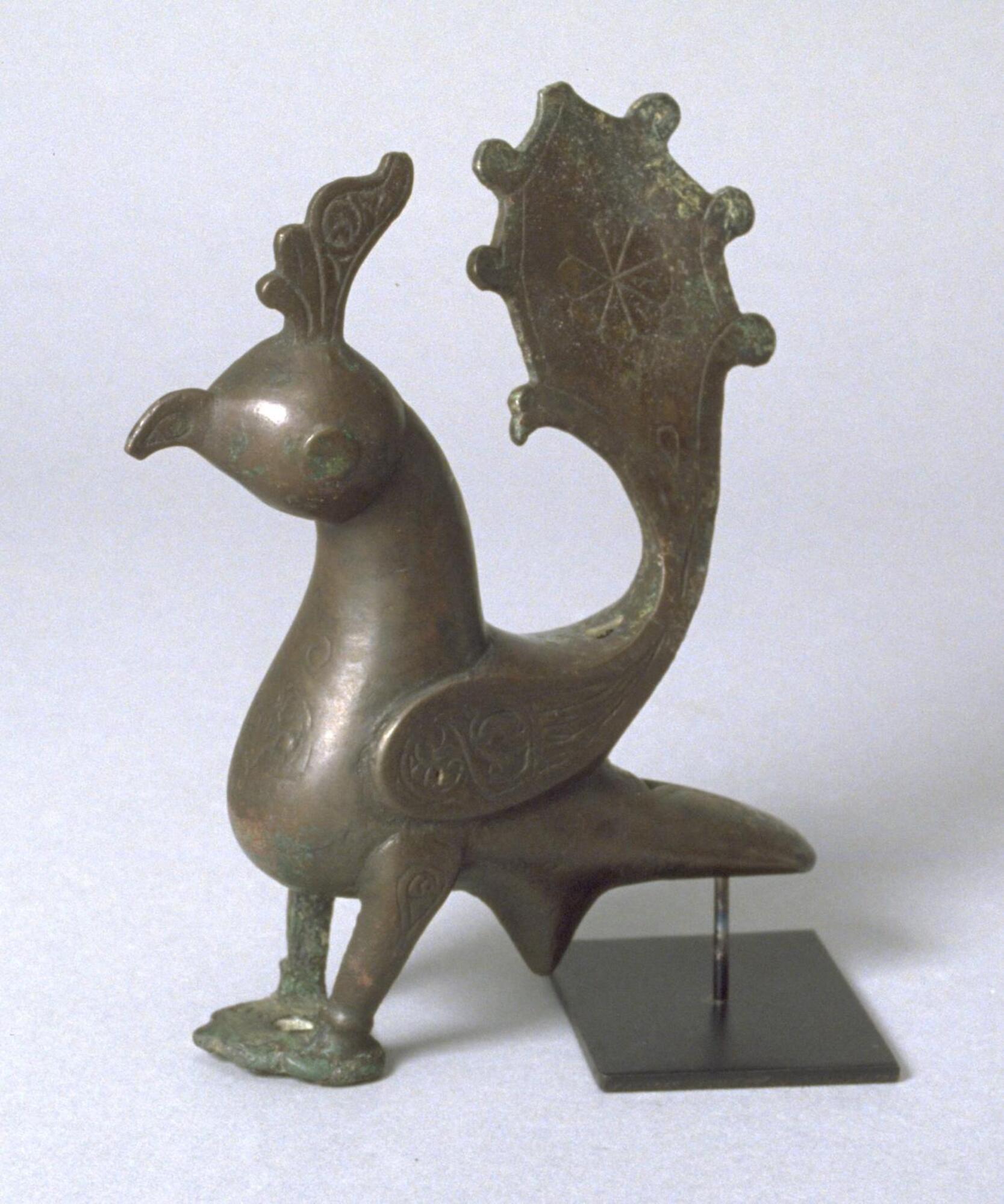 A bronze statue in the shape of a peacock, this piece has engraved decorations and is made in the Seljuk style of metalwork.