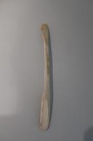 A double-sided kayak oar carved from ivory.