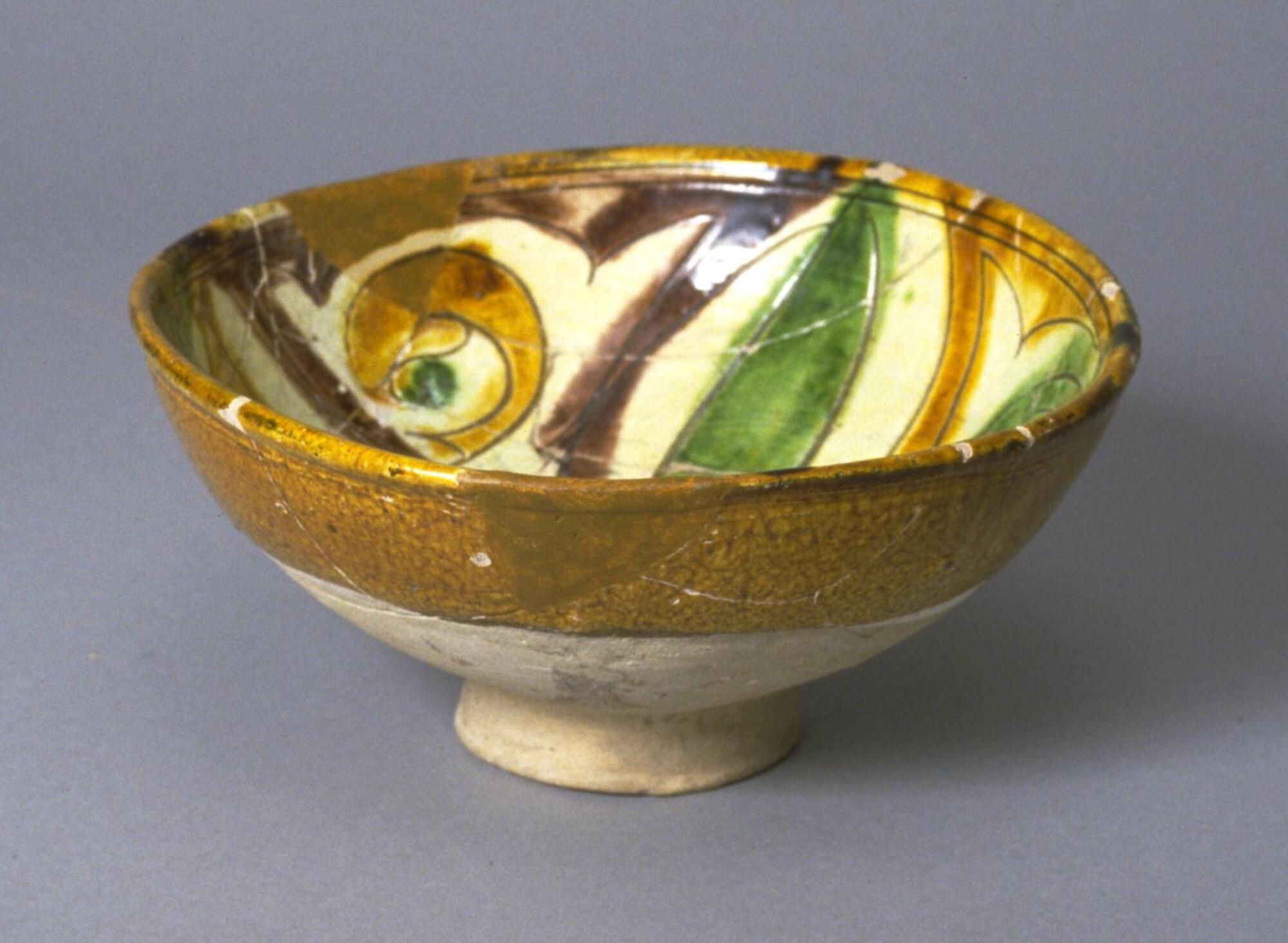 "In these vessels pigments were applied within the lines of a pattern incised into the slip, and then the interior was covered with a colorless glaze and the exterior with a yellow-brown one." (pg. 38)