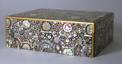 Lacquer ware box with mother-of-pearl inlay decoration combining geometric patterns, flowers, dragons, and scepters.