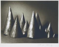 A group of varying sizes of cones on a table.