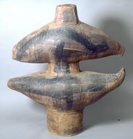 Large stoneware abstract sculpture with two balanced lateral crescent-shaped forms branching off a central conical structure.  Brown with loosely-painted broad brushstrokes in black and incised decoration of rows of dots in a “stitching-like” pattern<br />