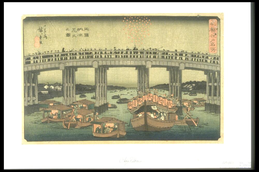 People are standing on the huge arch bridge over water, viewing the boats with red lanterns sailing on the water.