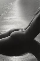 This work shows a nude figure lying prone, her torso extending out of frame, spine arching upwards, creating a shadow across the bottom of the composition. 