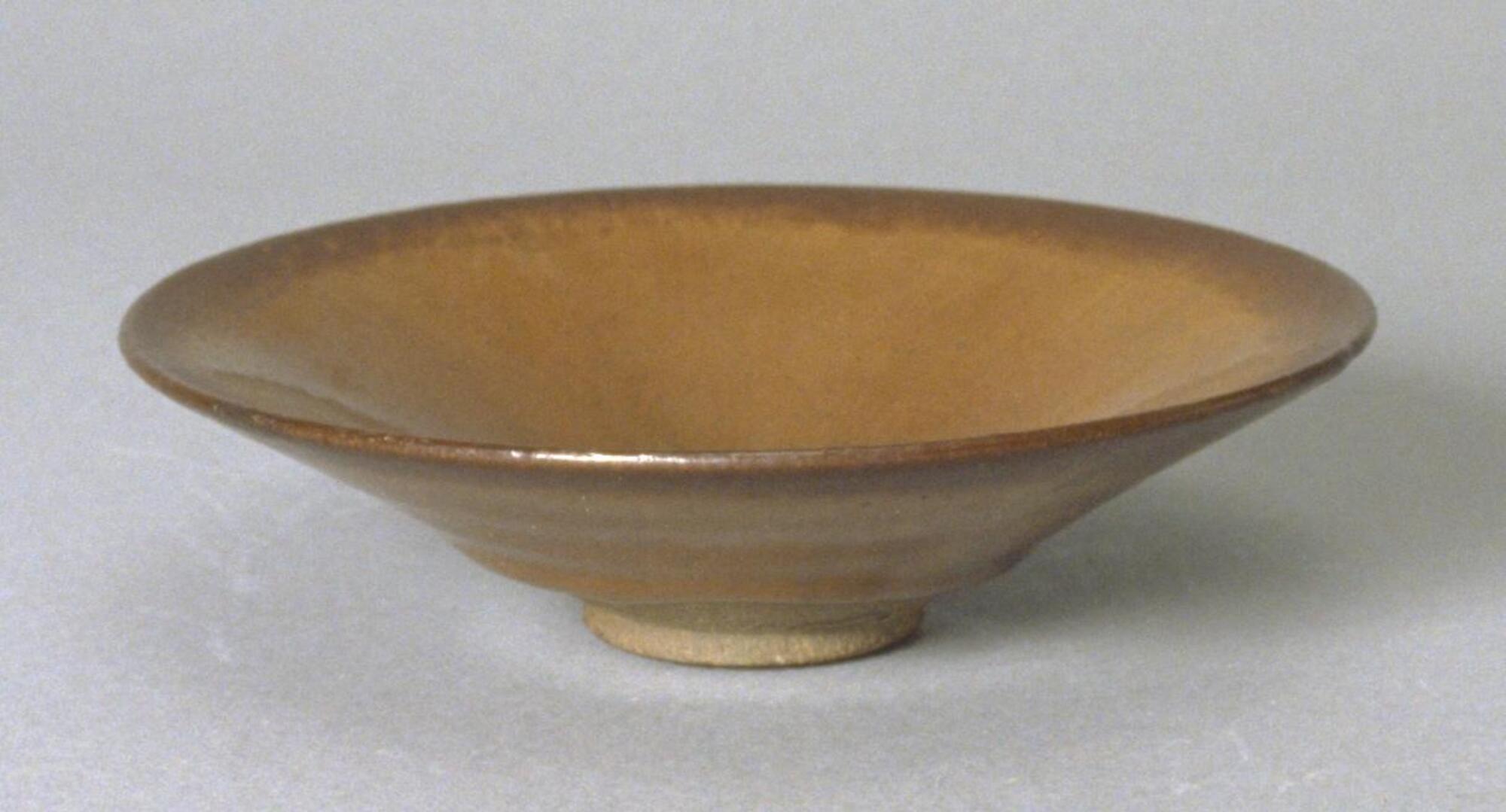 Shallow, wide conical light grey stoneware bowl on a tall straight foot ring, covered in a dark brown-black glaze with intense, and copious russet hare's fur (兔毫盏 <em>tuhao zhan</em>) markings.