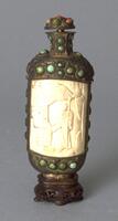 A Mongolian snuff bottle consisting of ivory and copper. Carved on the ivory is a pavilion and man with a staff standing in front of it. Incised in the in the copper are balls of turquoise. On top is a copper stopper incised with balls of turquoise.