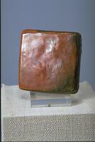 Square ceramic tile with iridescent orange glaze