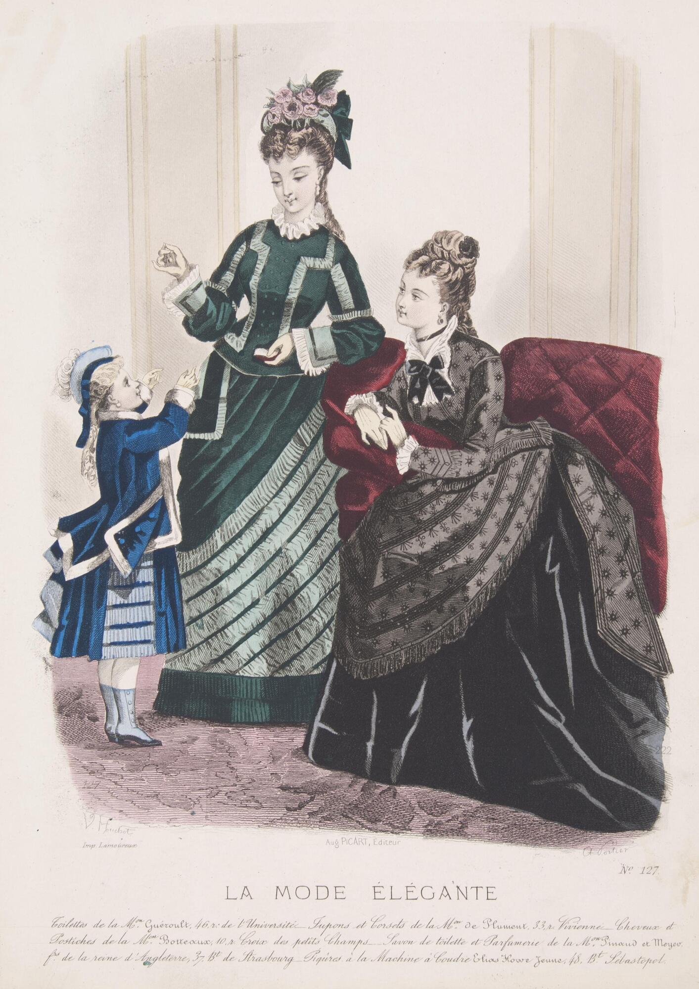 This colored engraving depicts two women and one child in elaborate dress. The central figure is a woman standing in a dark green dress decorated with lighter green trimmings. Her hair is gathered in a headpiece made up of green ribbons and pink flowers. To the right of her a woman in a black and grey dress sits on a burgundy chaise. The child standing on the left of the composition is outfitted in a navy blue and pale blue costume with a jacket trimmed in white. The child reaches toward something kept in the standing woman’s left hand.<br />