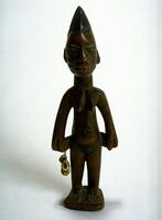 Standing female figure on a square base. The hands are at the sides,  one of which holds a string of cowrie shells. The figure has prominent breasts and on the face there are three horizontal marks on each cheek. The hair is a in a round, comb-like shape. 