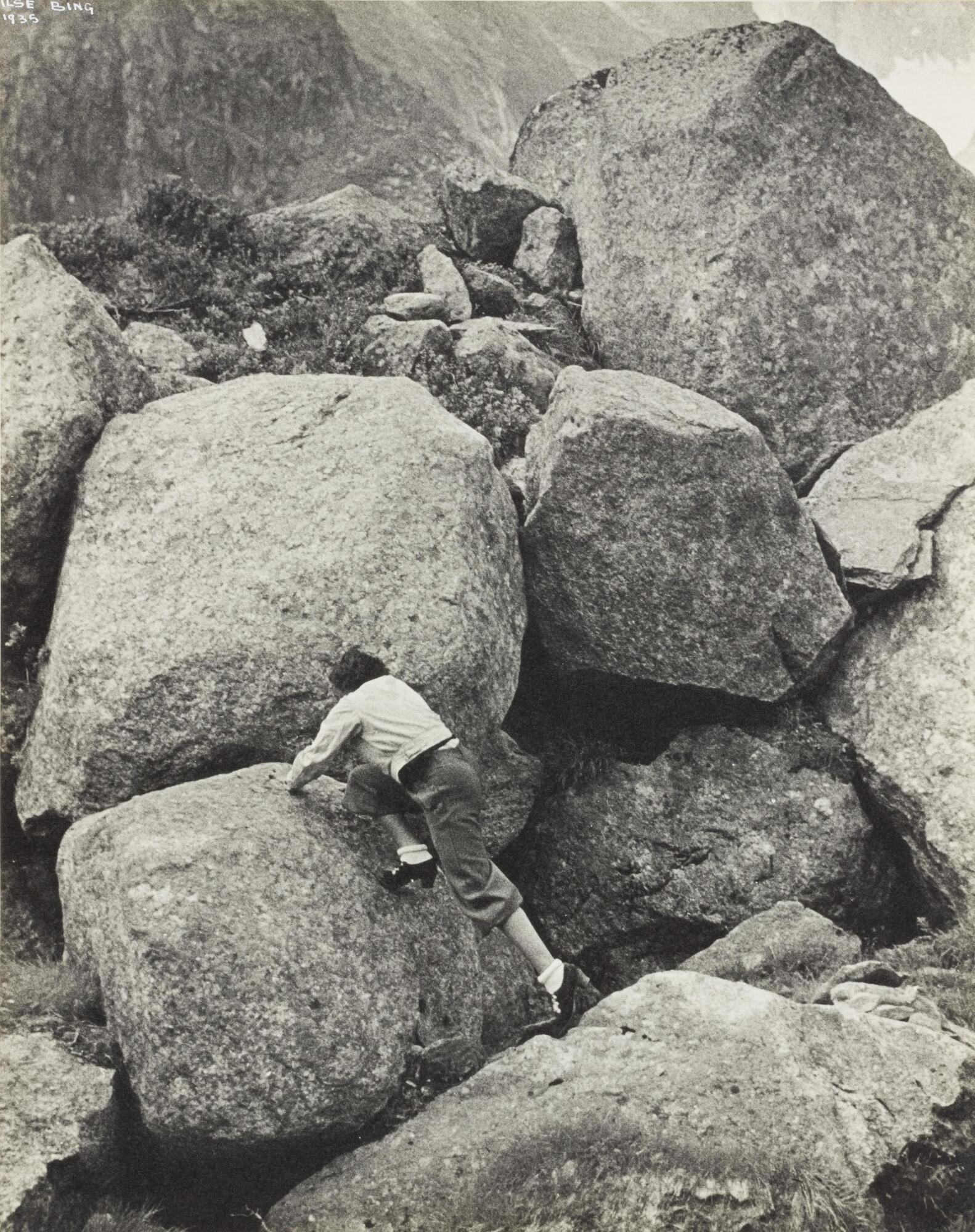 View of a woman rock-climbing.