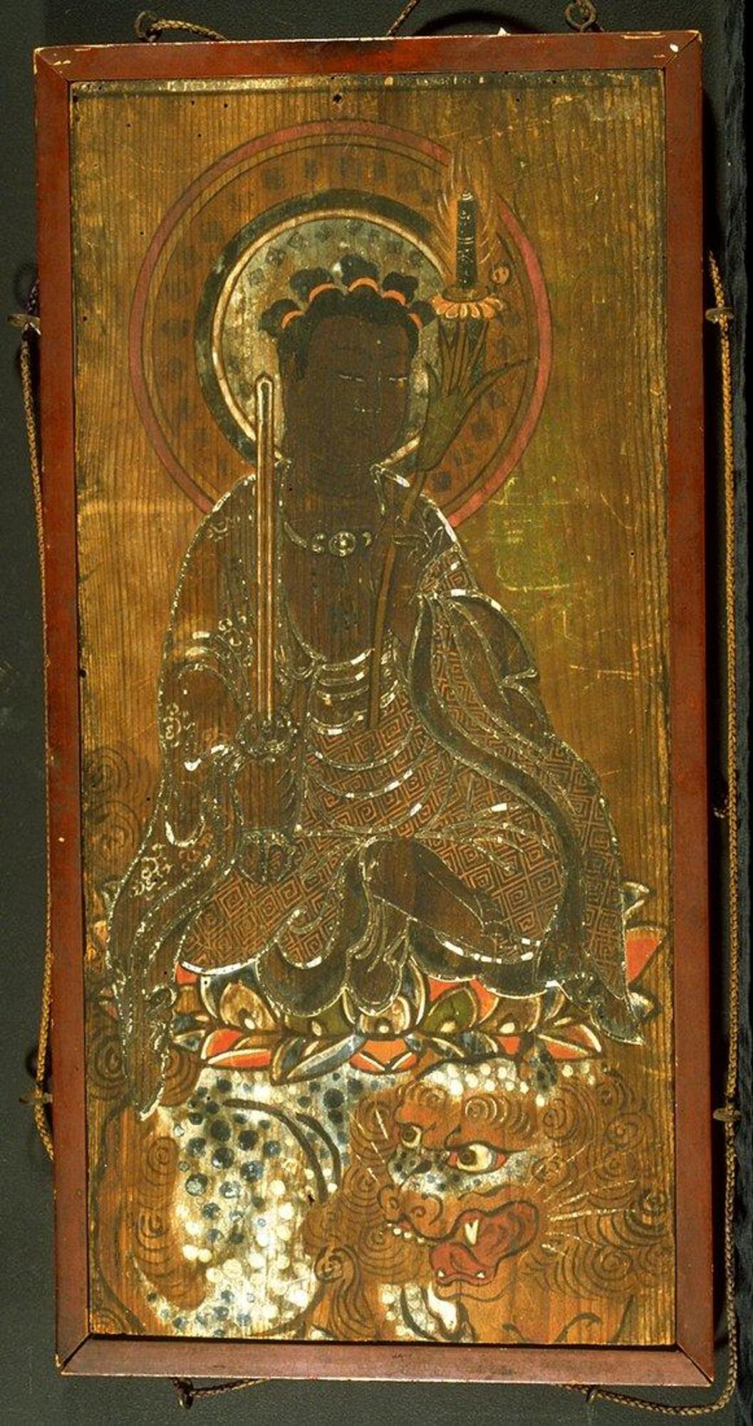 This depiction of Monju (Sanskrit: Mañjuśrī), the bodhisattva of wisdom, shows him seated on his typical lion mount, holding a vajra sword and lotus, upon which rests a sutra scroll. While most of the pigments have deteriorated with age, the brightly colored lotus and dappled skin of the lion suggest the original vibrant colors of the image. 