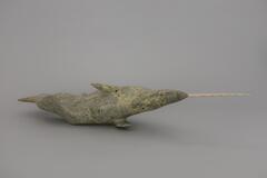 An ivory tusk carved in a corscrew pattern. It fits into the hole on the top of the Narwhal sculpture.&nbsp;