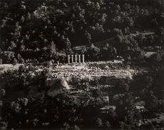 This photograph depicts an aerial view of an ancient temple surrounded by trees.