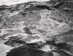 This photograph depicts an aerial view of a valley with sunken terraced circles.