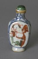 A porcelain snuff bottle painted with a depiction of (Budai?). On top is a glass stopper.