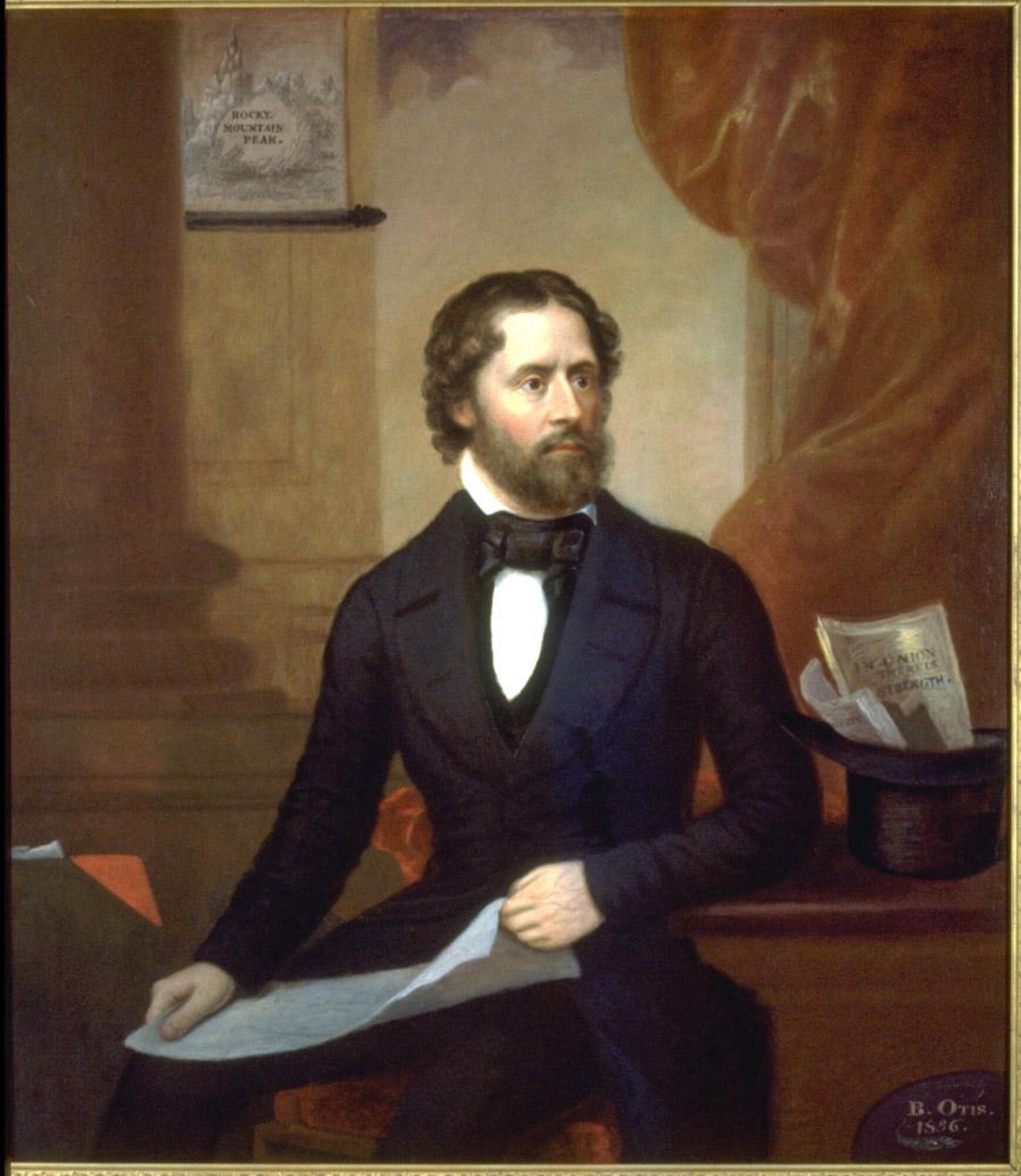 Portrait of seated man in black suit holding a sheet of paper. Subject is seated in front of a column, exposed sky (?) and red curtain/drapery. Larson 2/5/18