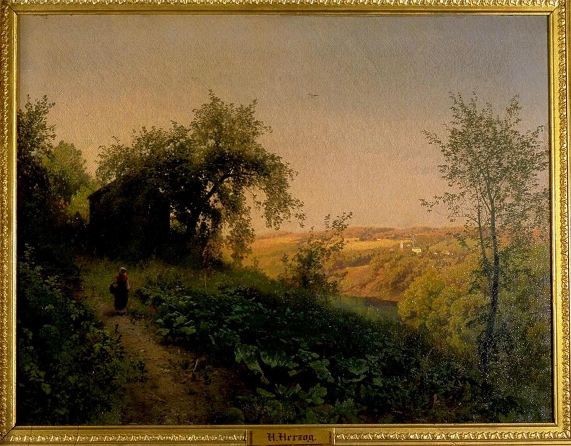 This painting depicts a lush green countryside with an expanse of blue sky. It shows a hillside overlooking a small lake. There is a vista of fields and hills that extends beyond the lake to the horizon.<br />
In the foreground, a woman wearing a long dress and a bonnet and carrying a walking stick and basket, walks toward the viewer along a dirt path. The path runs from a building on the far left toward the bottom of the painting. The vegetation is painted in sharp detail in dark tones of green and brown.<br />
In the right half of the composition, there is a scene of a distant village and farms viewed through the trees on the edge of the hillside. In contrast to the shadowy wooded area, the view is bathed in bright sunlight. There is a lone bird in flight in the light blue sky that fills the top half of the painting.