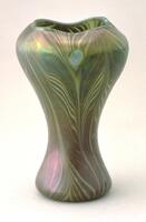 This vase in iridescent glass consists of a large swelling shoulder that tapers towards a narrow base. The decoration in mauve, pink, blue and brown includes feather designs, including peacock tail &quot;eye&quot; design.
