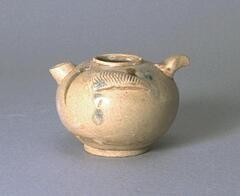 A stoneware globular ewer on a footring with a wide mouth and a straight, short thick spout on one side opposite a short, curved, protruding handle.  There are two cross-hatched curved appliques on opposing shoulders of the ewer.  It is covered in a straw-colored celadon glaze with underglaze iron oxide and suffused blue splashes. 