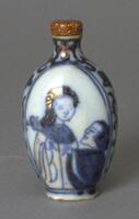 A porcelain snuff bottle with blue underglaze that has a design of a European male wooing a Chinese woman. At the top of the snuff bottle is a brown glass stopper.