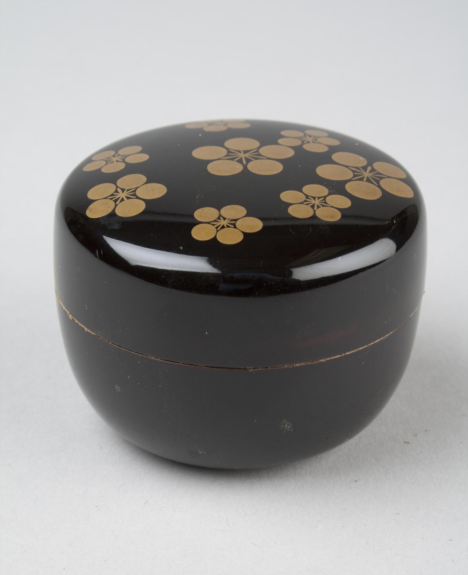 Black square box with gold flowers on the top.
