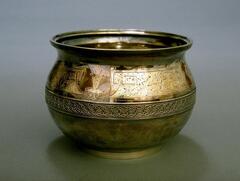 Silver jar-shaped vessel with flared lip and a band of decoration around center of the body