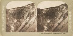 This black and white stereoscopic image features two images of the grand canyon. A deep valley with a river flowing through two steep hillsides.