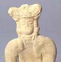 The moulded head of the terracotta figurine represents a royal personnage. He wears a three-lobed crown, spherical earrings, and a necklace. He is seated with his legs bent from the hips at right angles to the upper part of the body. The legs are crossed and thus form a circular base which allows the essentially two-dimensional figure to remain erect. The assembling of the limbs was apparently done after the figurine had been cast.